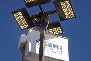 Man in cherrypicker working on lightpost